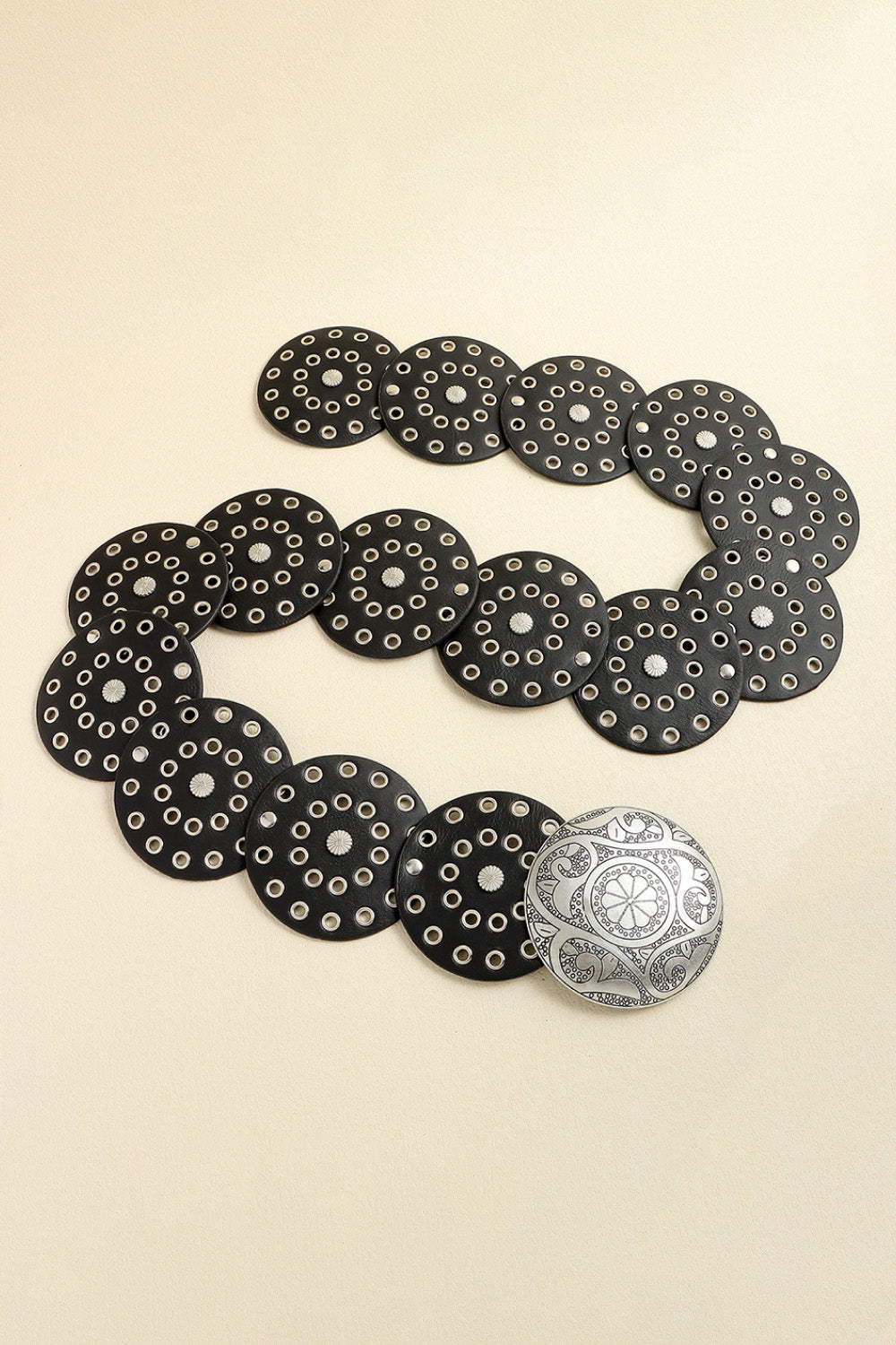 Black leather belt with silver disc embellishments and a decorative silver buckle.