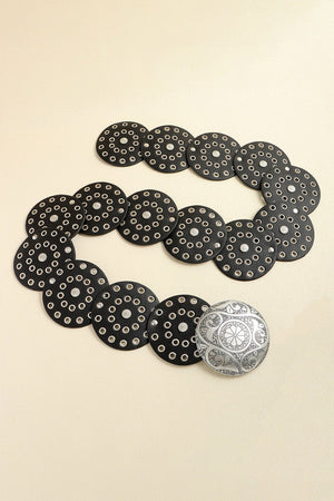 Black leather belt with silver disc embellishments and a decorative silver buckle.