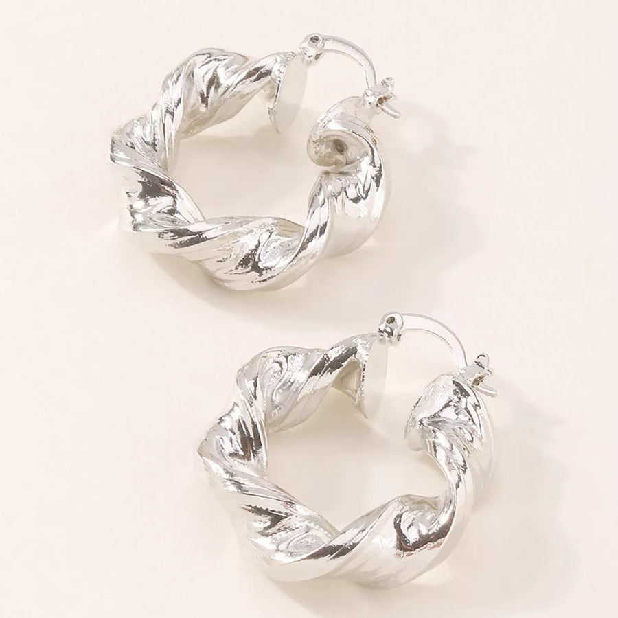 Textured hoop earrings in silver with a twisted design.