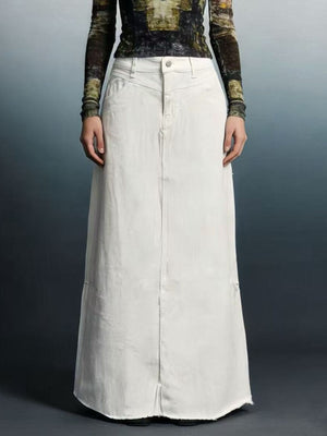 White denim maxi skirt with raw hem and button closure.
