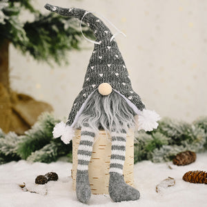 Light gray knitted gnome ornament with white hearts, striped legs, and pom-pom accents.