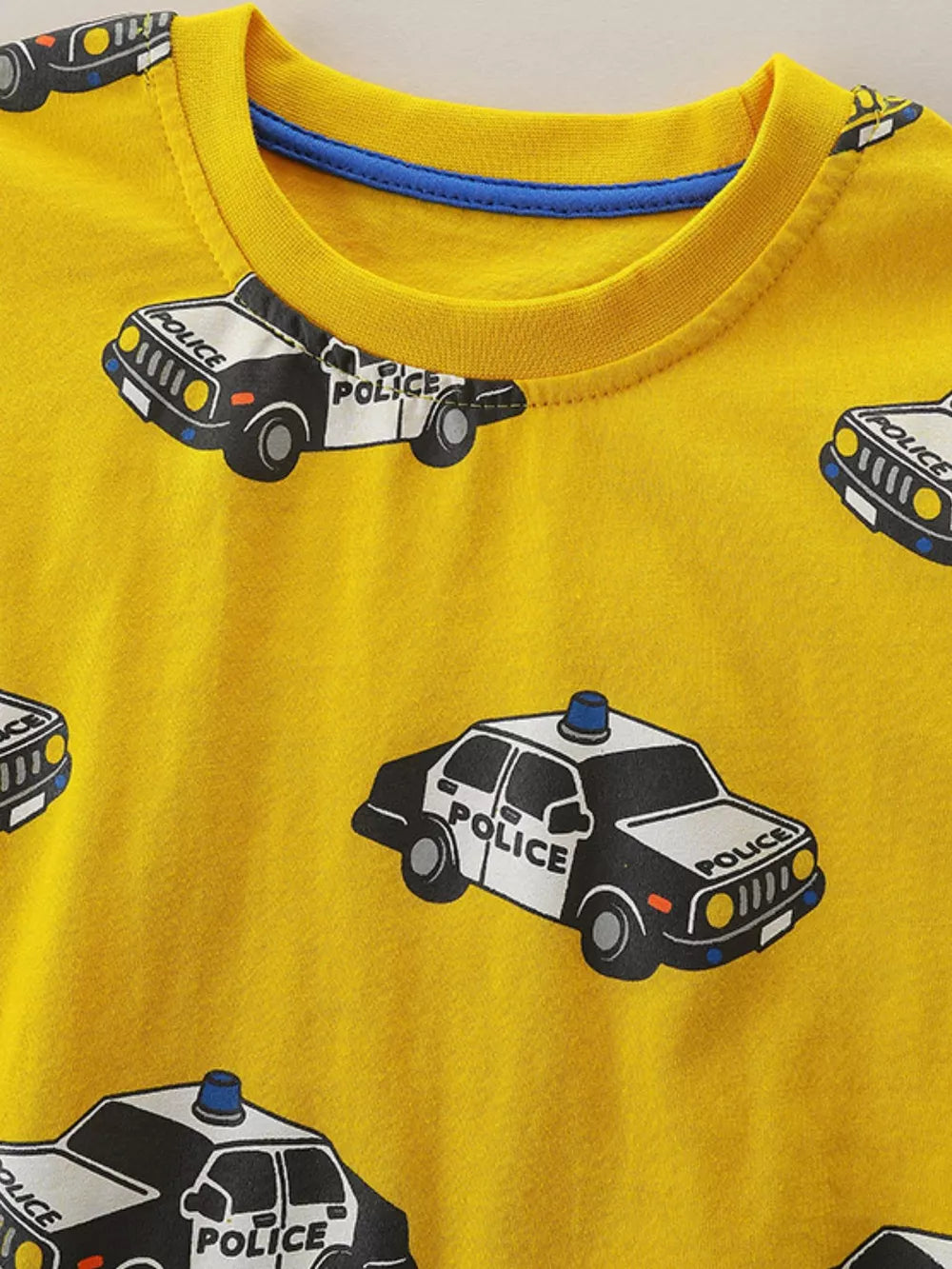 Yellow cotton blend crew neck t-shirt with a playful police car print for babies.