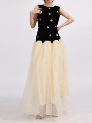 Black velvet sleeveless dress with sequin floral embellishments and a cream tulle skirt.