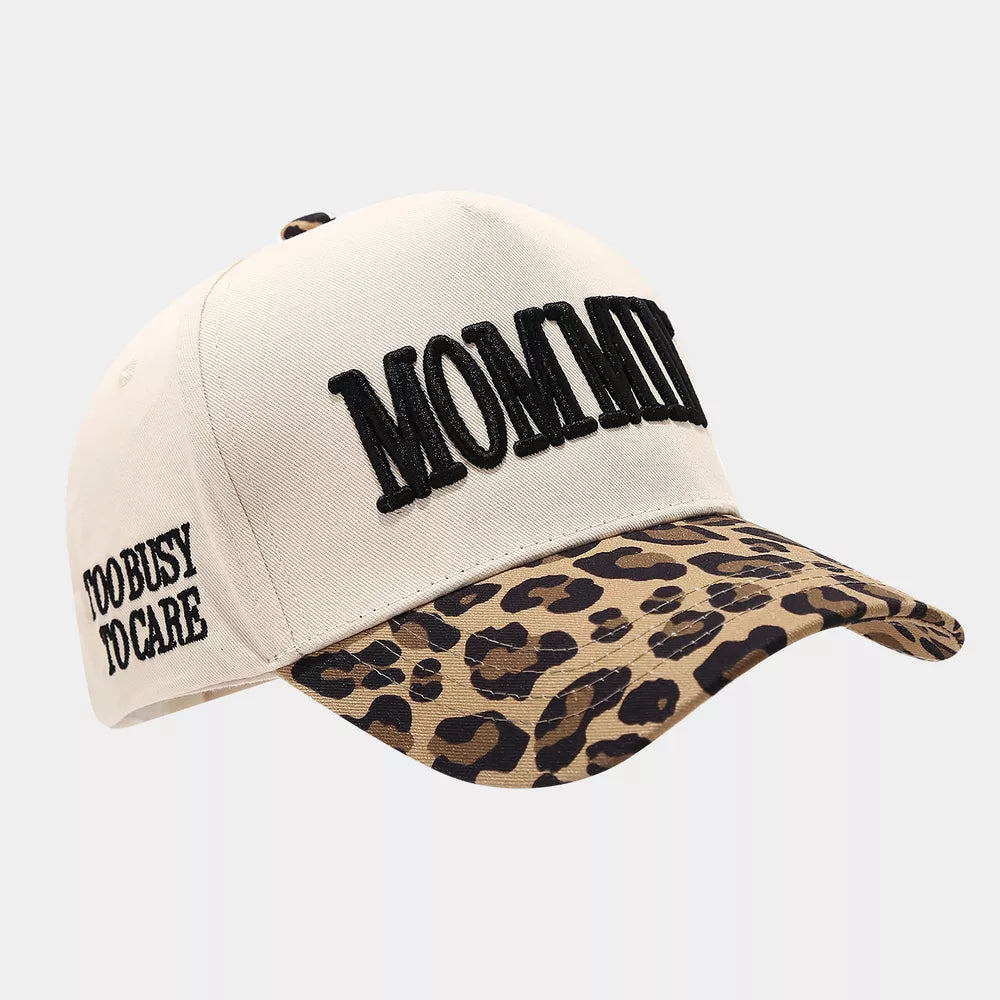 tan cap featuring embroidered slogan and leopard-print