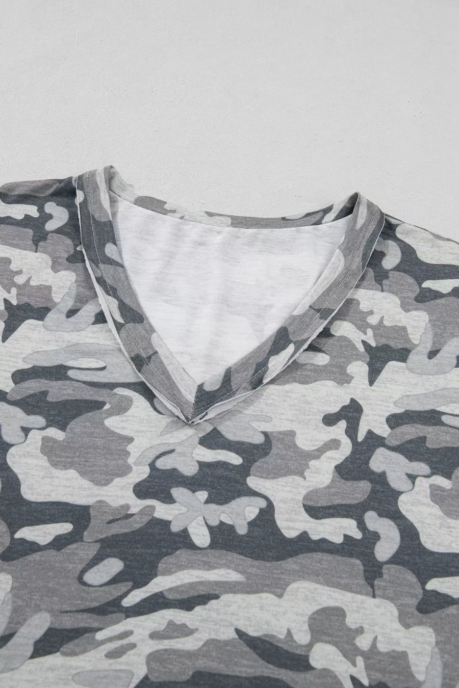 Grey camouflage V-neck relaxed tee with a soft cotton blend fabric.