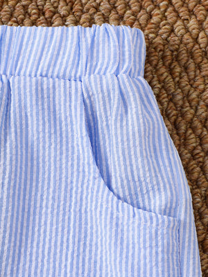 Baby blue and white striped seersucker shorts with elastic waistband and pocket detail.