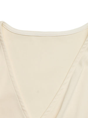 Cream surplice bodysuit with cap sleeves and a ribbed texture.