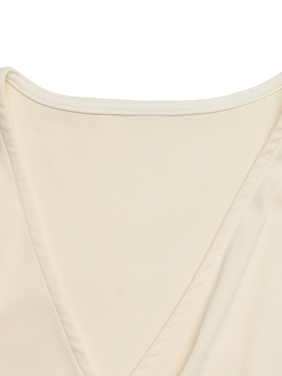Cream surplice bodysuit with cap sleeves and a ribbed texture.