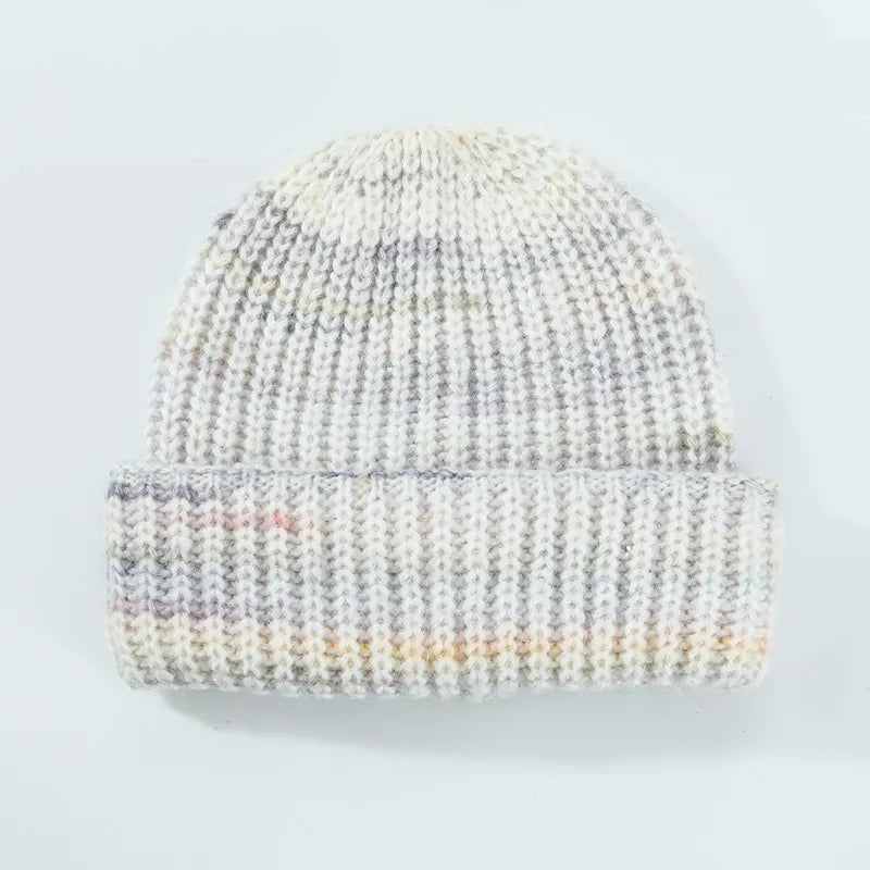 Textured mélange ribbed beanie in cream with subtle colorful flecks.