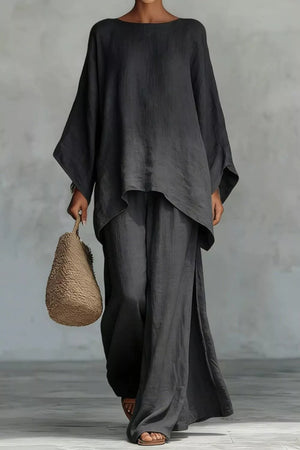 Black polyester two-piece set with flowing top and wide-leg pants.