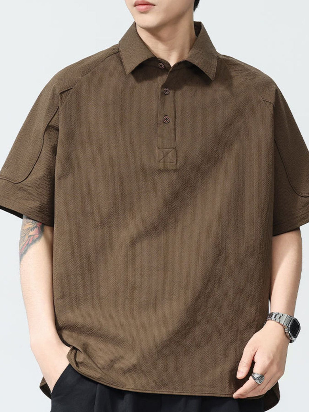 Brown textured short sleeve polo shirt with button-down collar and two-button placket.