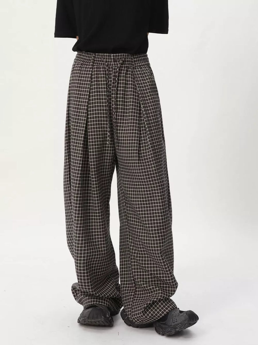 Plaid wide-leg relaxed fit pants in dark check with adjustable drawstring waist.