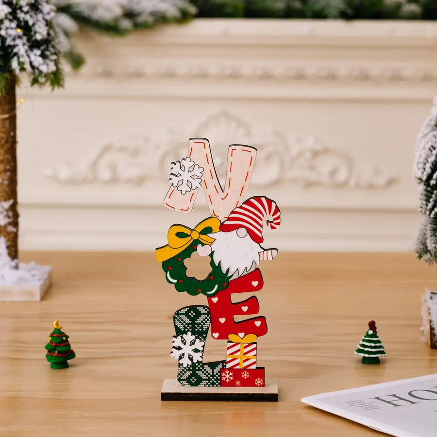 Wooden holiday word block set with gnome and wreath, spelling NOEL.