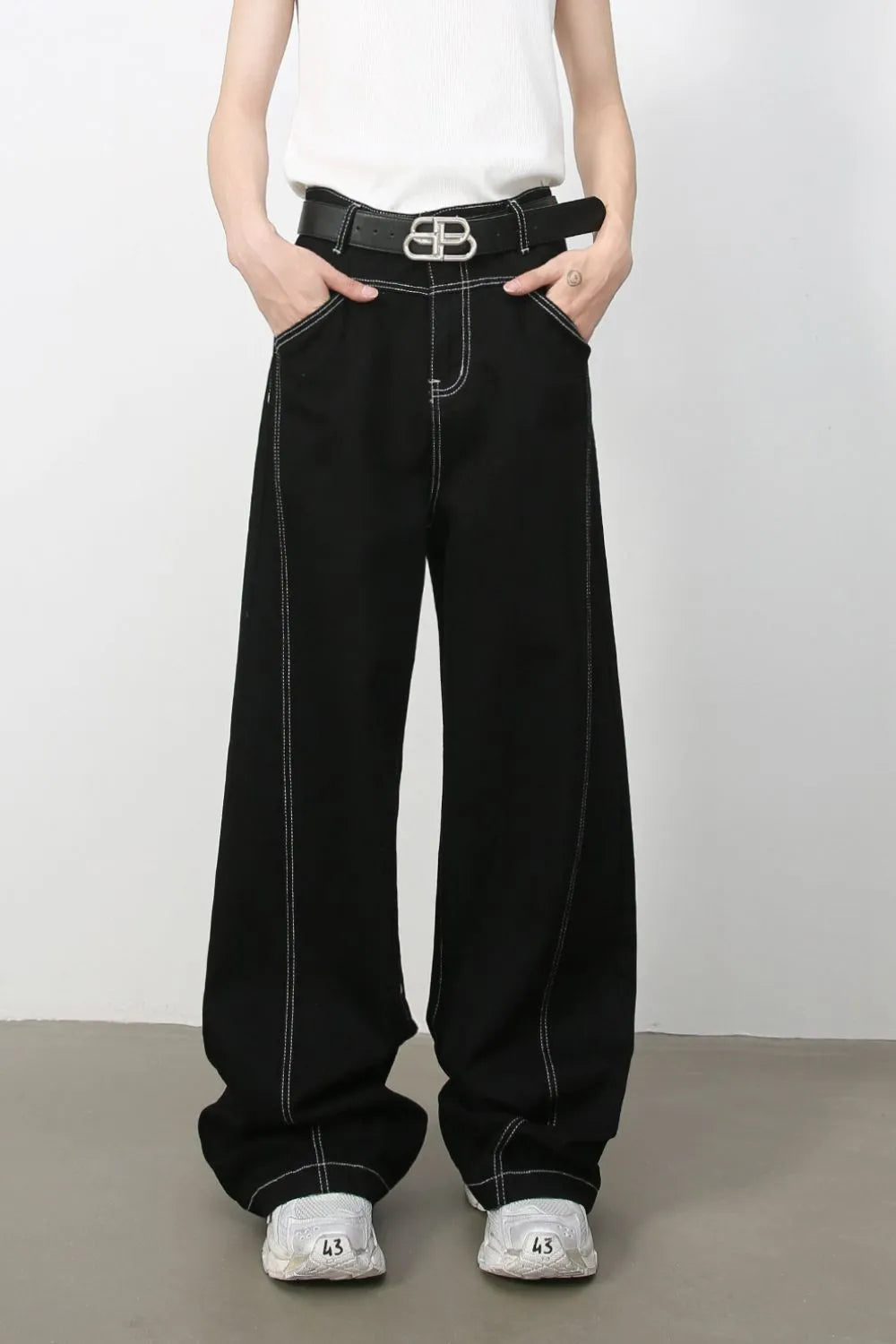 Black relaxed fit denim jeans with contrast stitching and a wide leg.