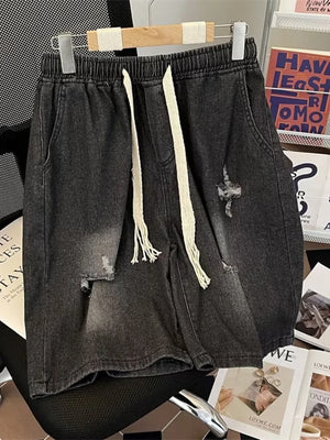 Black distressed denim shorts for men with drawstring waist and frayed details.