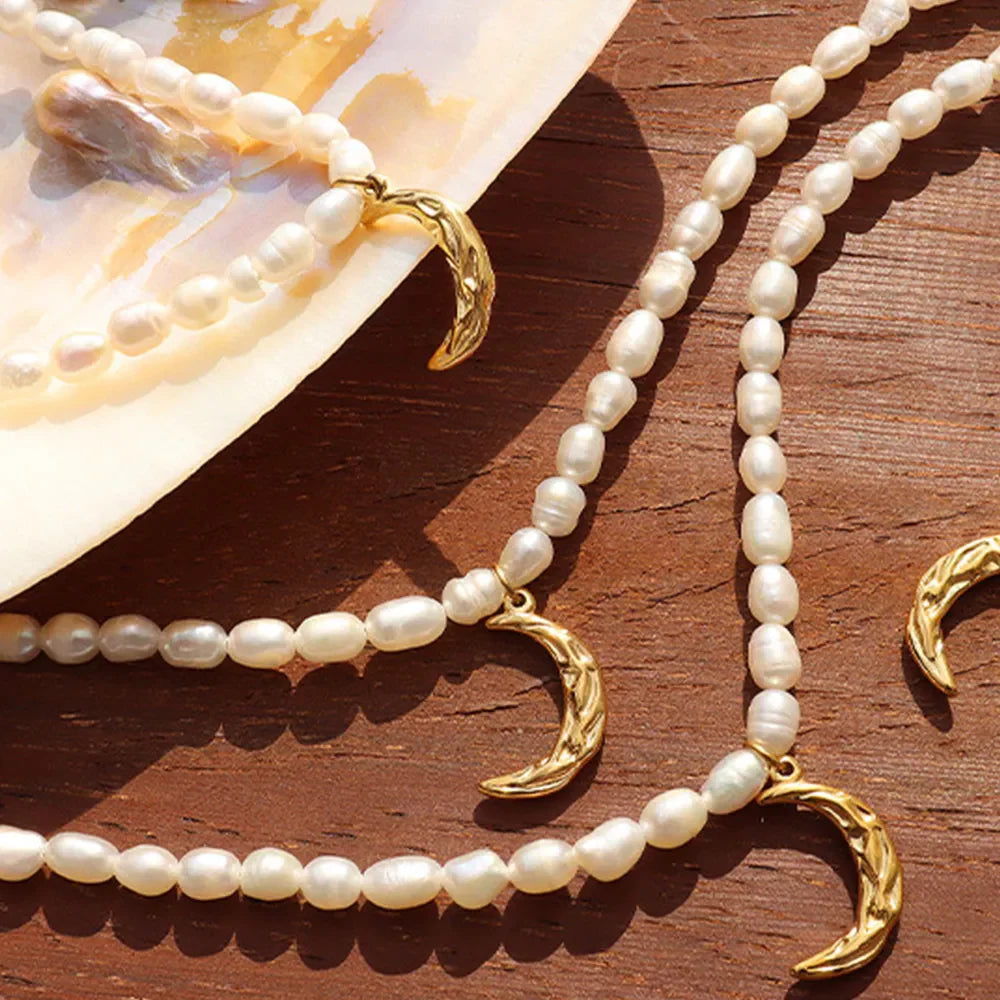 Gold pearl necklace with crescent moon charms, delicate celestial jewelry.
