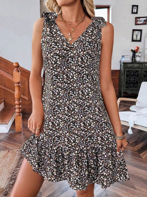 Floral tie strap mini dress in black with ruffled hem and v-neckline.
