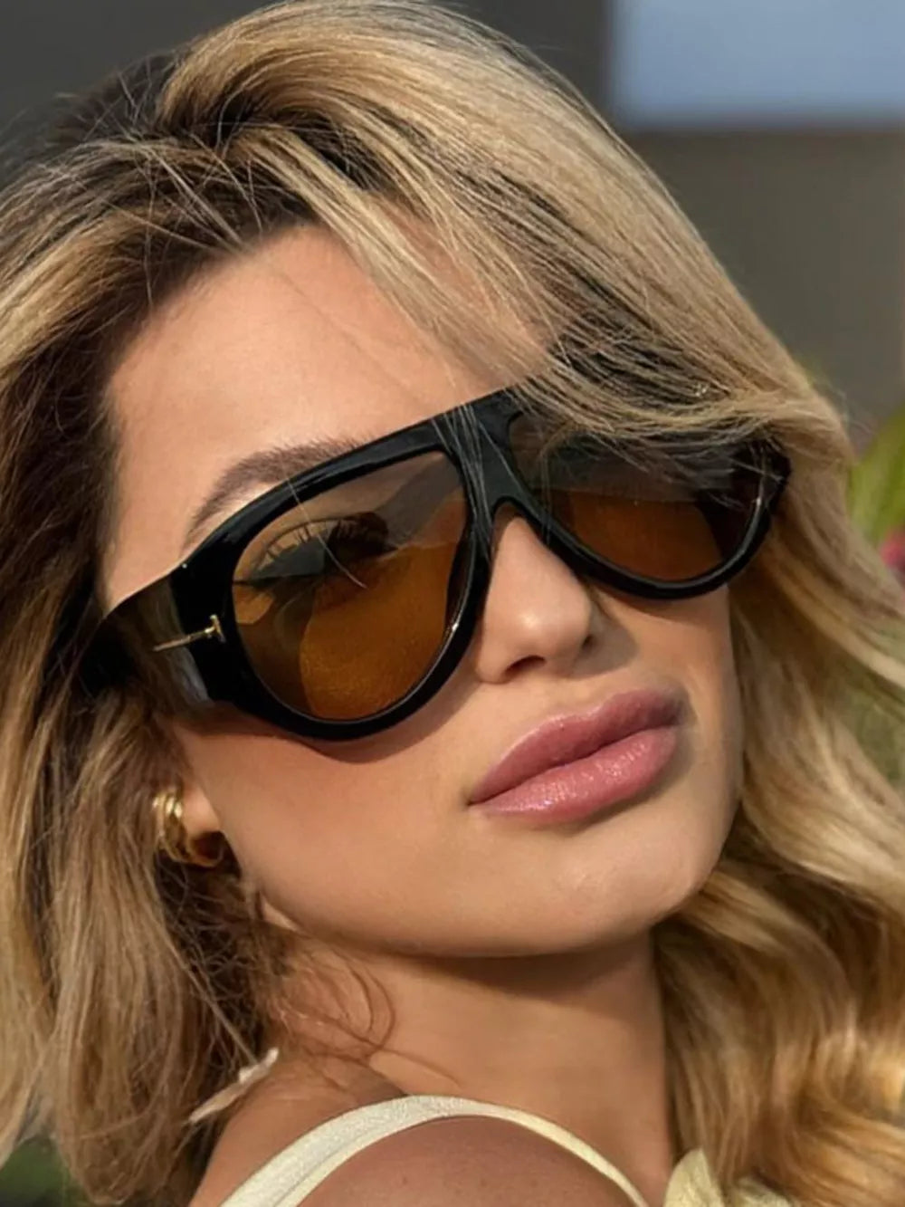 sunglasses in black featuring UV400 protection and oversized fit