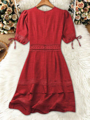Red lace-embellished V-neck mini dress with tie sleeves and tiered hem.