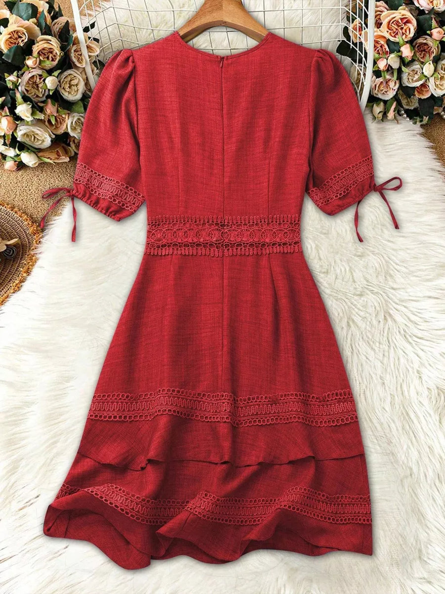 Red lace-embellished V-neck mini dress with tie sleeves and tiered hem.