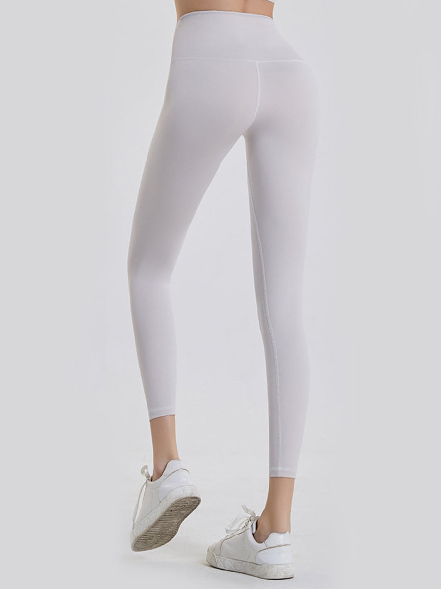 White 7/8 length leggings with a wide waistband and seamless stitching detail.