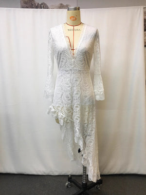 White lace asymmetrical V-neck dress with bell sleeves and ruffled hem.