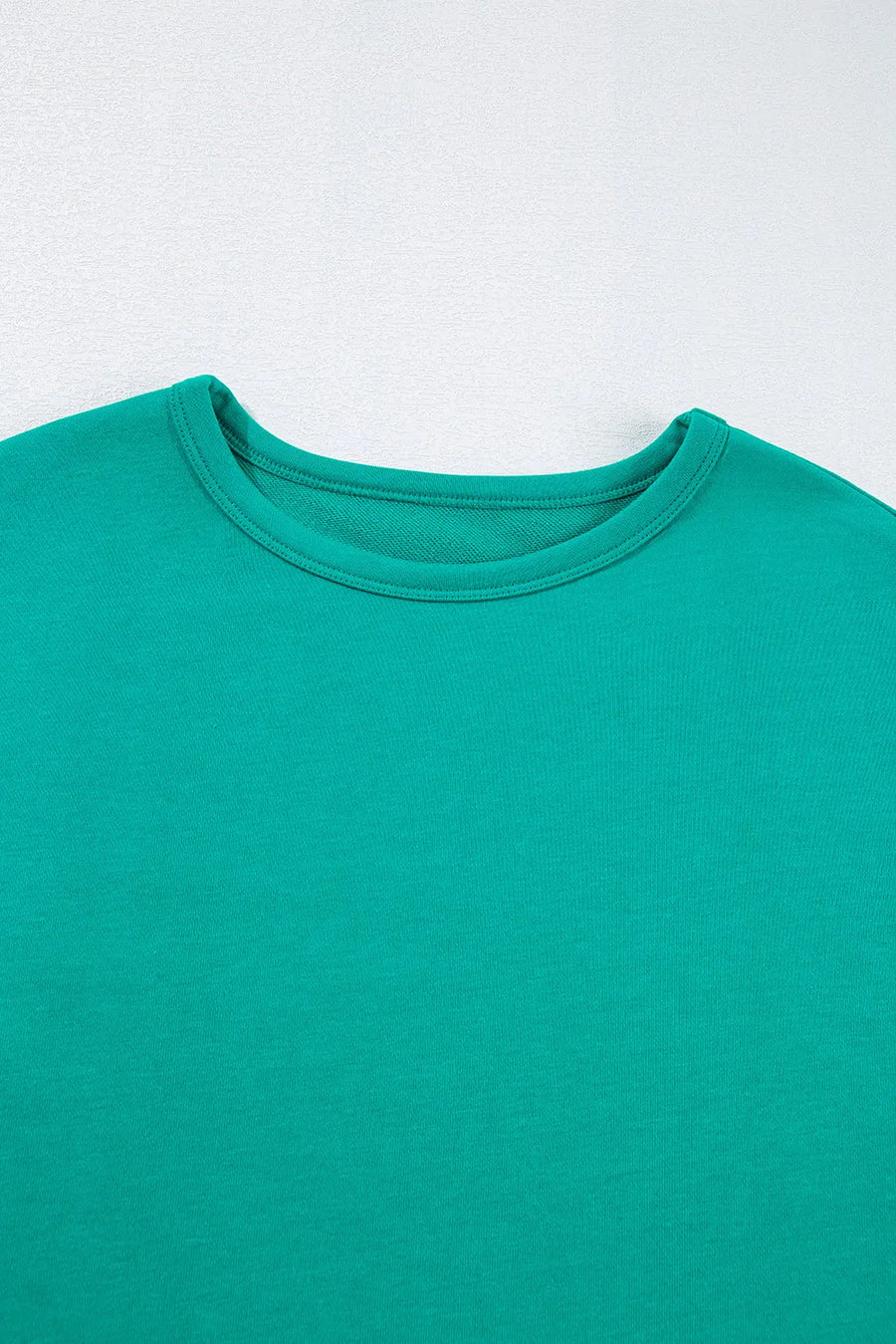Turquoise crewneck sweatshirt with relaxed fit and crew neckline.