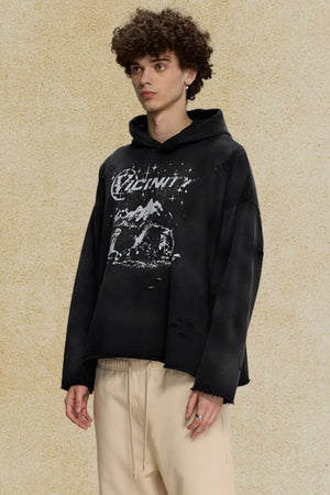 Black oversized distressed graphic hoodie with ripped details and a crew neck.