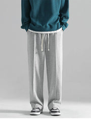 Grey casual drawstring sweatpants with a loose fit and clean front seams.