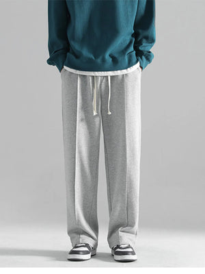 Grey casual drawstring sweatpants with a loose fit and clean front seams.