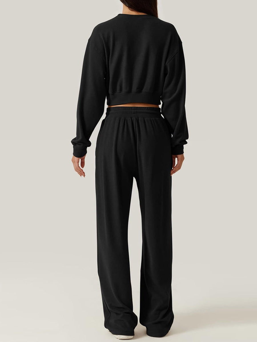 Black knit lounge set with cropped sweatshirt and wide-leg pants
