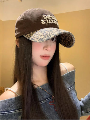 Brown cotton baseball cap with leopard brim and embroidered text.