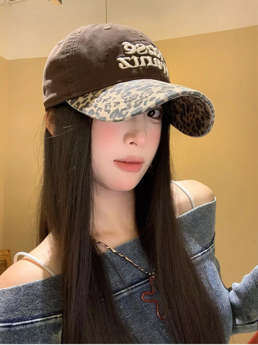Brown cotton baseball cap with leopard brim and embroidered text.