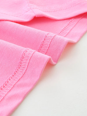 Pink cotton t-shirt detail showing double-stitched hem and seams.