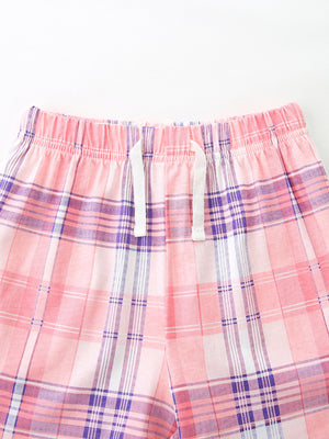 Pink plaid cotton shorts with elastic waistband and white drawstring detail.