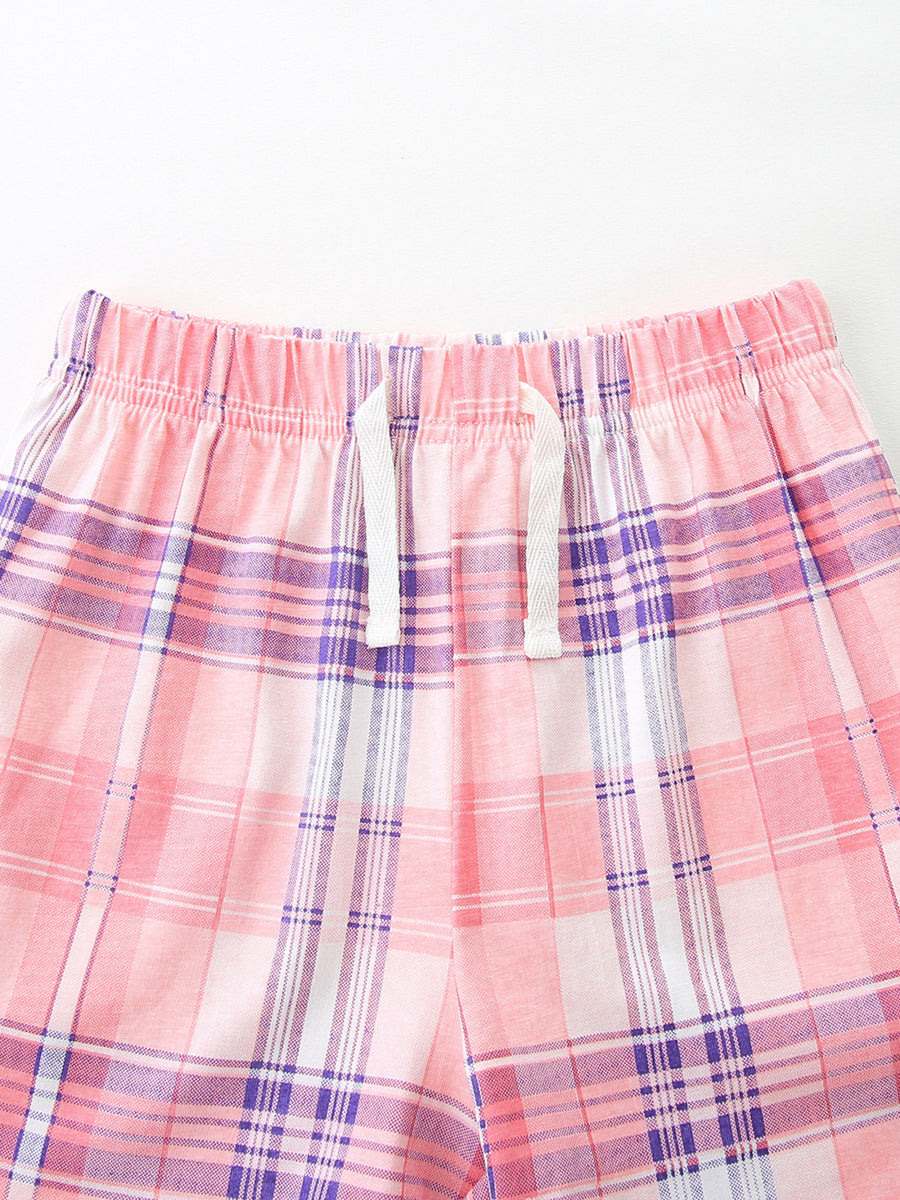 Pink plaid cotton shorts with elastic waistband and white drawstring detail.