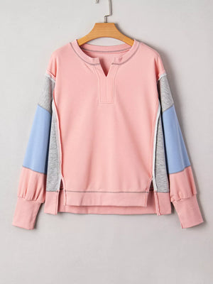Oversized dusty pink sweatshirt with contrast color block sleeves and split hem.