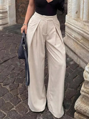 Elegant high-waisted wide-leg cream trousers with pleats and a relaxed fit.