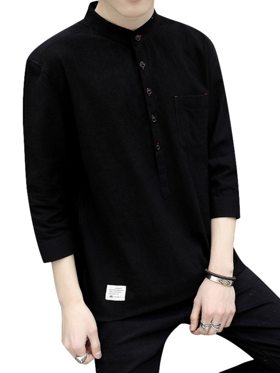 Black cotton relaxed-fit shirt with band collar, button detail, and chest pocket.
