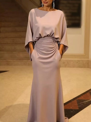 Maxi dress in light purple with batwing sleeves, ruched waist detail, and pockets.