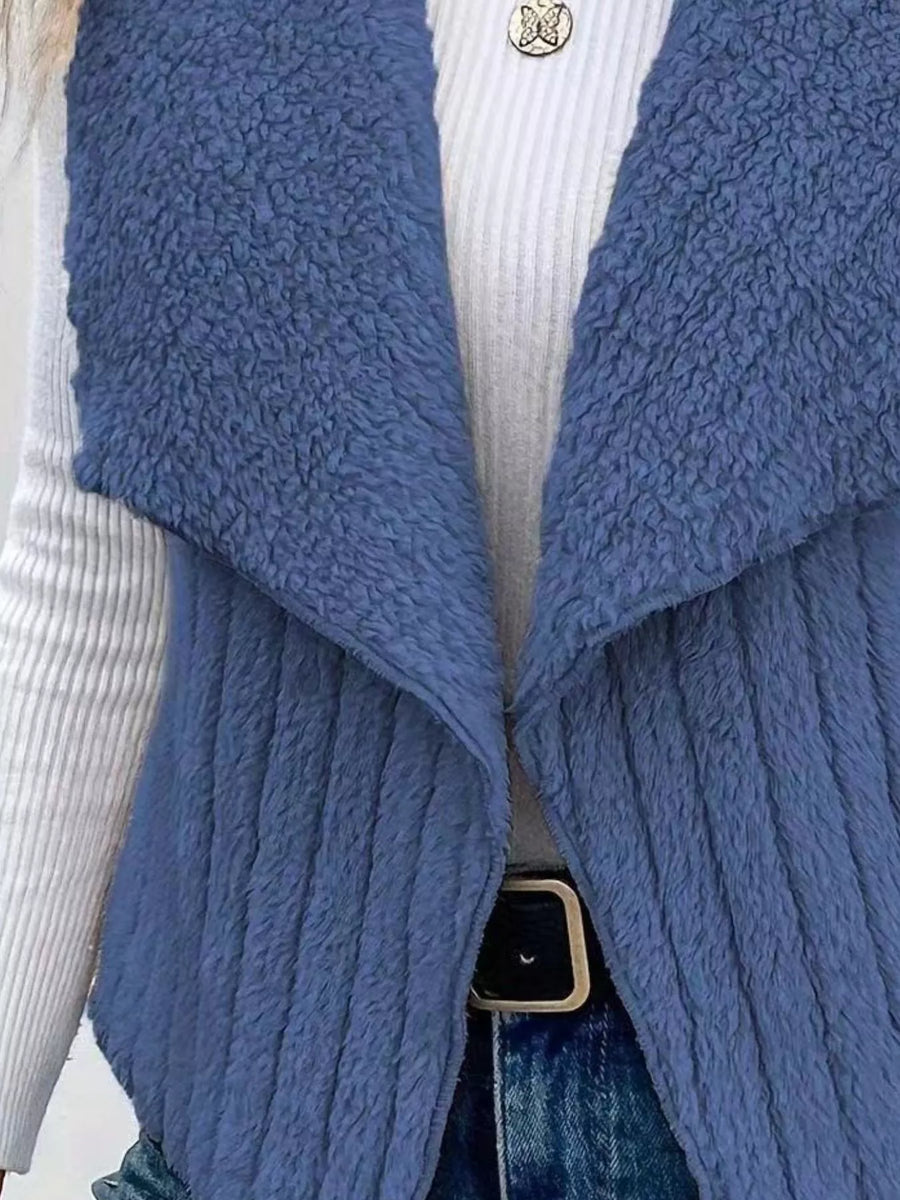 Blue fleece vest with open front and shawl collar, textured material.