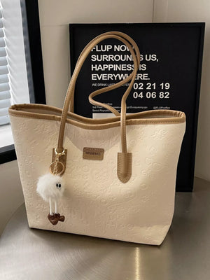 Khakis embossed PU leather tote bag with a fluffy charm and tan straps.