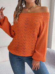 Pumpkin open-knit off-shoulder sweater with voluminous sleeves and intricate leaf pattern.