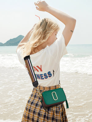 crossbody bag in dark green featuring adjustable strap and rectangular fit