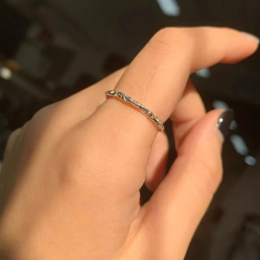 Silver ring featuring open band and textured