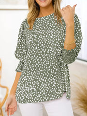 Green animal print half sleeve blouse with smocked cuffs.
