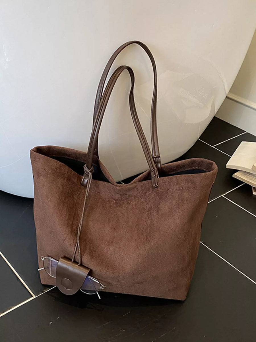 Large caramel brown suede tote bag with leather straps and glasses holder detail.