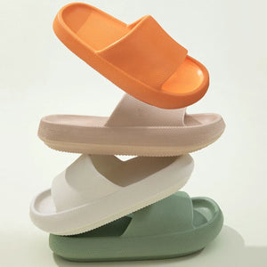 Textured cloud slides slippers in apricot, white, green, and orange.