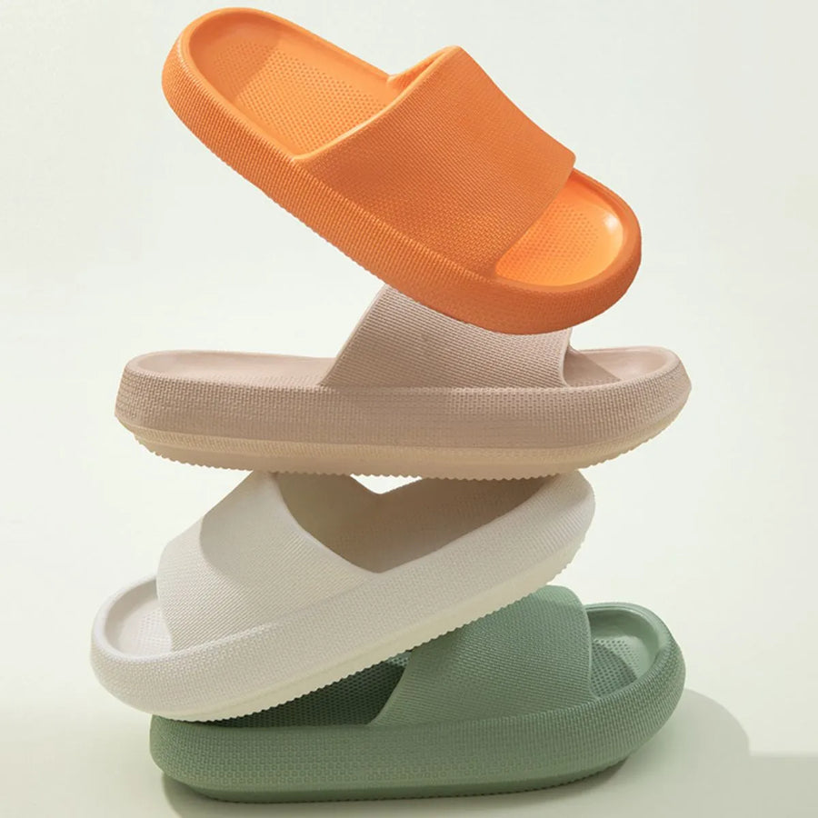 Textured cloud slides slippers in apricot, white, green, and orange.