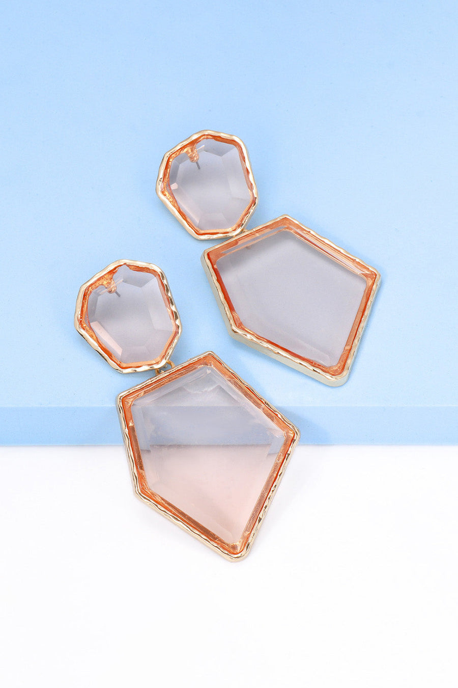 Resin facet drop earrings with gold trim in blush pink and clear.